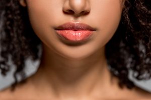 A girl with beautiful full red lips from getting 1ml lip filler from Dr Ifrah