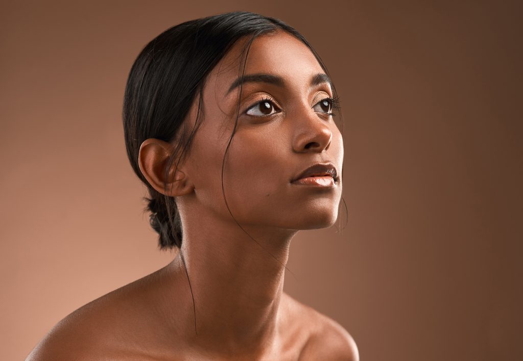 Beautiful dark skinned woman with rejuvenated skin and no wrinkles
